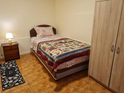 a bedroom with a bed and a wooden cabinet at Casa interior Playa Brava in Iquique