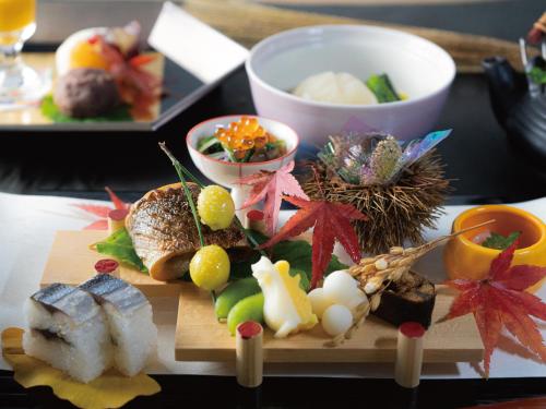 a plate of food with sushi and vegetables on a table at Umino Ryotei Okinawa Nakamasou in Onna