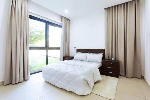 a bedroom with a large bed and a large window at Incredible 2 Bedroom Space Available in Accra