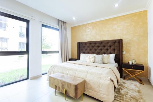a bedroom with a large bed and a large window at Amazing 2 Bedroom Room Space Available in Accra