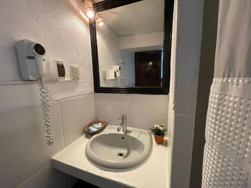 a bathroom with a sink and a mirror at SACRED STONE Boutique Hotel in Machu Picchu