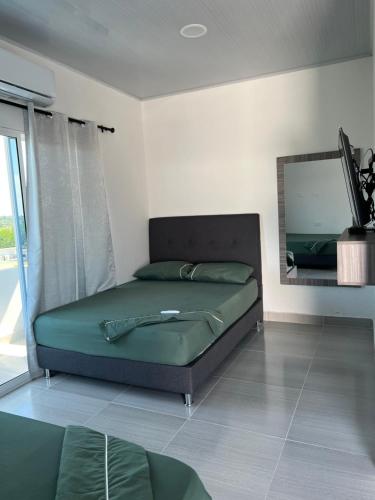 a bedroom with a bed in a room with a mirror at cabaña la bonita habitacion 302 in Doradal