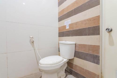 a bathroom with a white toilet in a room at RedDoorz Resort Premium @ Sangkan Hurip Kuningan in Kuningan