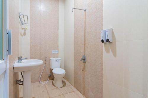 a bathroom with a toilet and a sink and a shower at RedDoorz Resort Premium @ Sangkan Hurip Kuningan in Kuningan