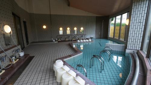 a large bathroom with a large swimming pool at glampark Serakoyu Land in Sera