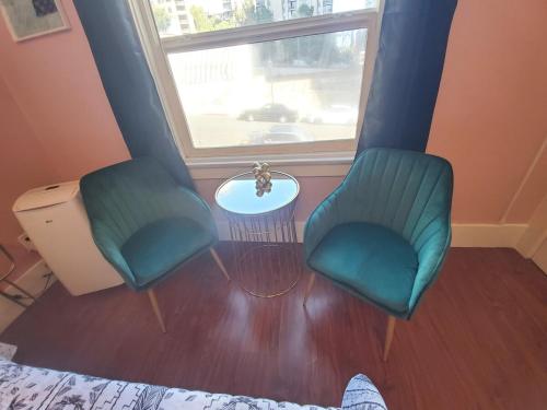two chairs and a table in a room with a window at The Chadwick in San Diego