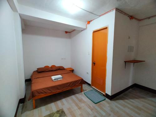 a bedroom with a bed and an orange door at Aunora Superior Room 