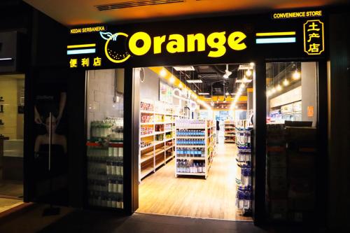 a grocery store with a orange sign on the door at Homesuite' Home at The Loft in Kota Kinabalu