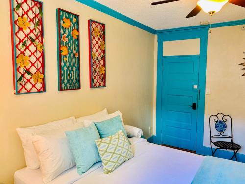 a bedroom with a bed with a blue door and stained glass at The Chadwick in San Diego