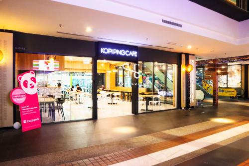 a store front with a sign in front of it at Homi Breeze at Sutera Avenue 和逸微风 in Kota Kinabalu