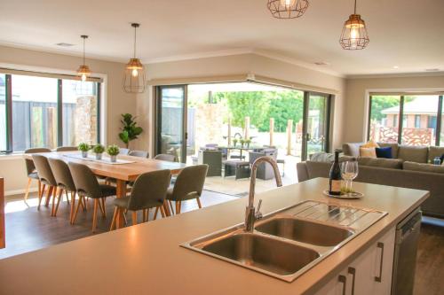a kitchen and living room with a sink and a table at Amaroo in Bright