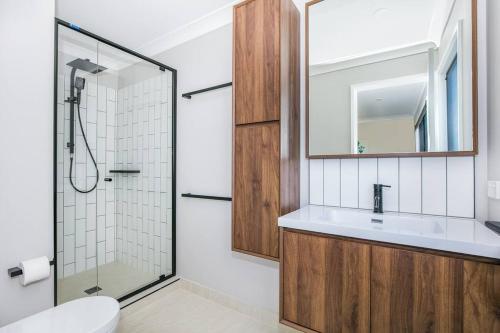 a bathroom with a sink and a shower at Cheerful 3 Bedroom townhouse with Parking in Gold Coast