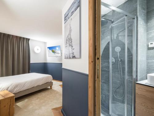 a bathroom with a shower and a bed in a room at Appartement Courchevel 1650, 4 pièces, 8 personnes - FR-1-618-28 in Courchevel