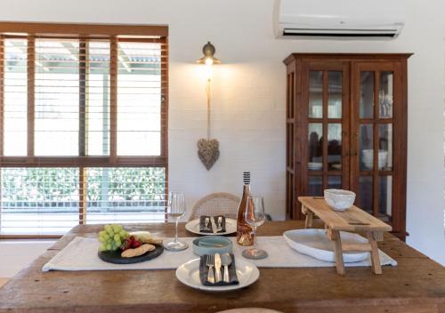 a kitchen with a table with plates of food on it at Sweetacres Hunter Valley in Pokolbin