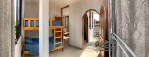 a room with a bunk bed and a hallway at Departamento a 3 cuadras de la plaza principal in Puerto Maldonado