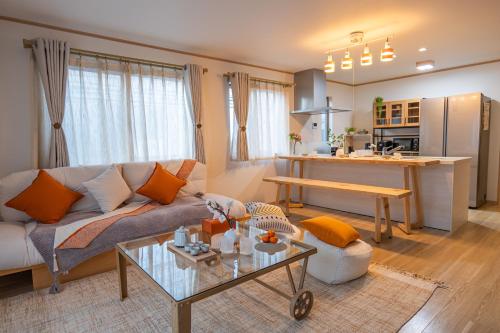 a living room with a couch and a table at 桜の川9 池袋一戸建 2-12人丨Ikebukuro Villa 2-12 people in Tokyo