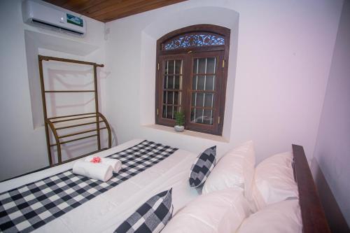 a living room with a couch and a window at Villa RISITHENMI in Ahangama