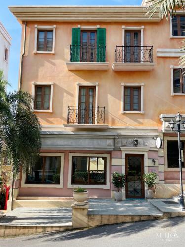 a building with windows and balconies on a street at Mellon OASIS Phu Quoc in Phu Quoc