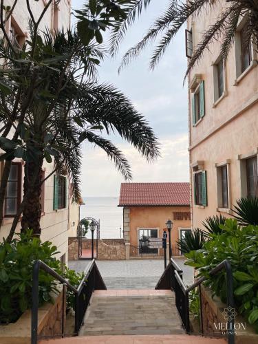 a street in a town with a palm tree and a building at Mellon OASIS Phu Quoc in Phu Quoc