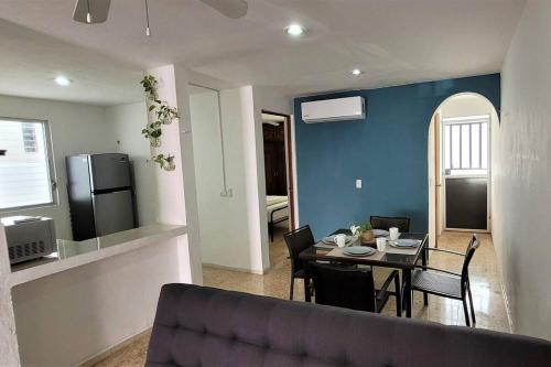 a living room with a couch and a table with chairs at Un rinconcito en Mérida in Mérida