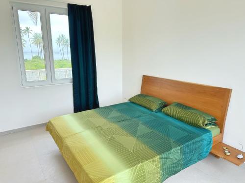 a bed in a white room with a window at Tropical Gem: 3-BR Beach Villa in Pingwe