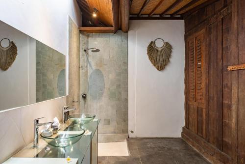 a bathroom with two sinks and a shower at Villa Lina by Optimum Bali Villas in Canggu