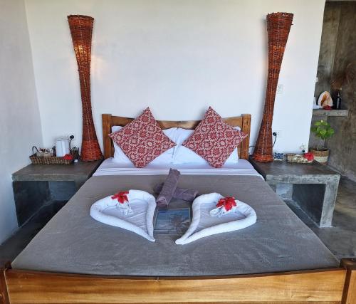 a bedroom with two beds with towels and pillows at Bamboo Surf Beach in San Isidro