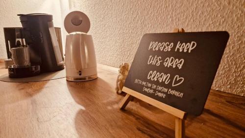 a chalkboard sign sitting on a table with a coffee maker at Gästehaus Goldenes Lamm in Rothenburg ob der Tauber
