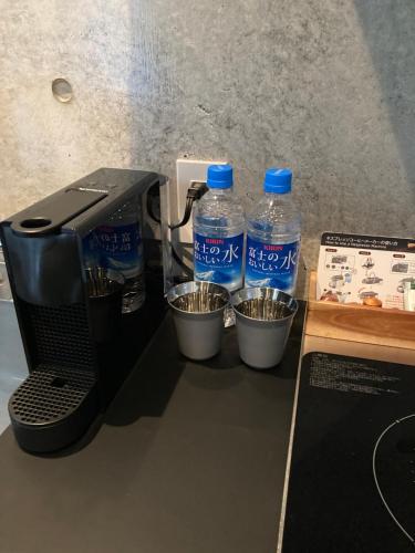 two bottles of water are sitting next to a printer at G.bouquet in Nakijin