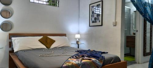 a bedroom with a bed and a table with a lamp at Breezy La Vista on the Terrace in Saint James