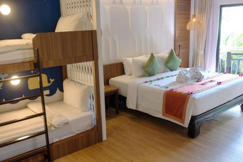 a bedroom with two beds and a bunk bed at Nipa Resort, Patong Beach - SHA Extra Plus in Patong Beach