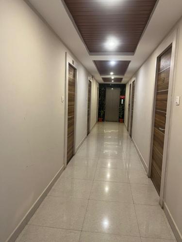 a corridor of an office building with a hallway at Hotel Avenue Suites Near International Airport Bangalore in Bengaluru