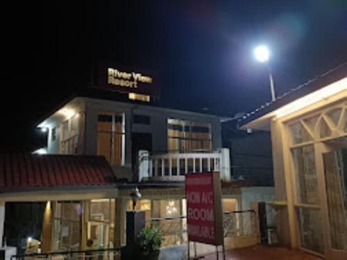 a building with a sign in front of it at night at River view resort Uttarkashi in Uttarkāshi