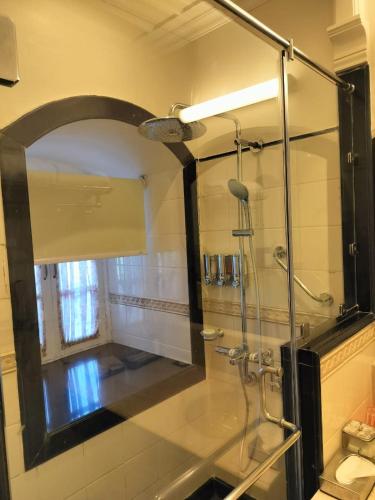 a bathroom with a glass shower with a mirror at Welcomhotel by ITC Hotels, The Savoy, Mussoorie in Mussoorie