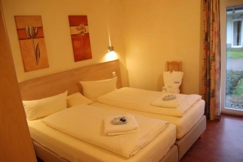 เตียงในห้องที่ 4 Sterne Apartment Kormoran mit Terrasse und Sauna