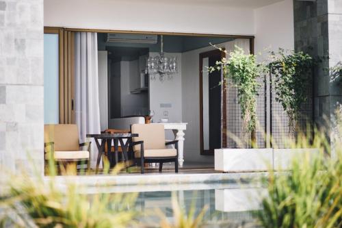 a dining room with a table and chairs at The Beach Samui in Taling Ngam Beach