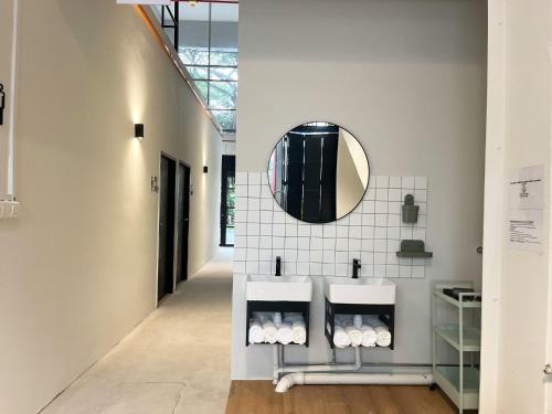 a bathroom with two sinks and a mirror on the wall at Code Hostel Singapore in Singapore