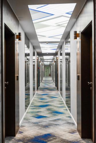 a hallway of a building with a carpeted corridor at Hotel Biss in Zenica