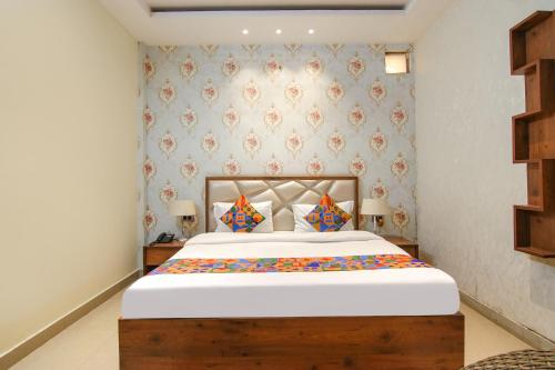 a bedroom with a large bed in a room at FabHotel K9 Regency in Dorāha