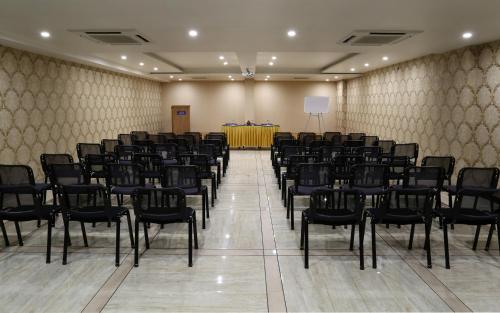 a conference room with chairs and a podium in the background at Grand Kailash Hotel in Aurangabad