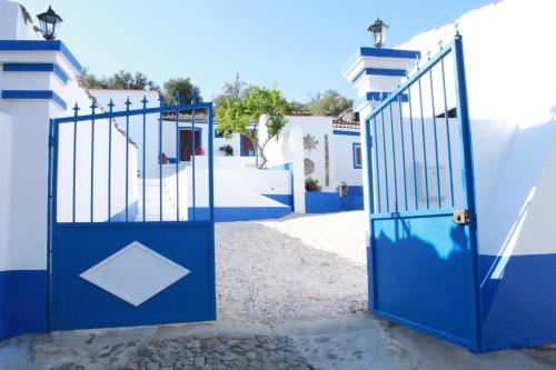 a blue gate in a blue and white building at Casa do Forte Elvas in Elvas