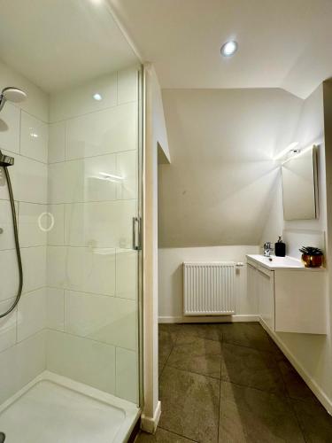 a bathroom with a shower and a sink at Luxury Suites Mons by Rikas Hotels in Mons