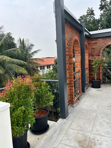 a patio with potted plants and a brick building at Limelights Premium Serviced Residences in Bengaluru