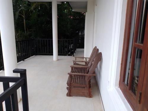 two chairs sitting on the porch of a house at Royal Inside Hotel in Udawalawe