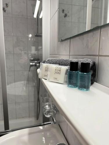 a bathroom counter with two bottles of soap and a sink at The Steakhouse - Guest Rooms in Sankt Johann im Pongau