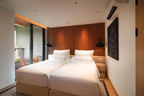 Cama o camas de una habitación en Beachwalk Residence