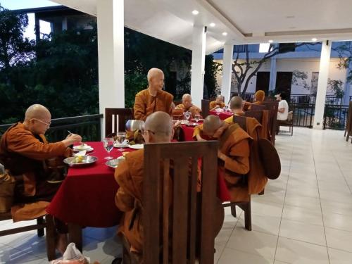 a group of monks sitting at a table in a restaurant at Four Points Resort - Anuradhapura in Anuradhapura