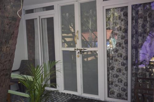 a sliding glass door with a cross on it at SUNBATH beach EXOTICA in Canacona