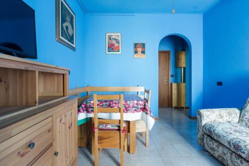 a blue room with a table and a chair at Roomy Apartment with Balcony! in Milan