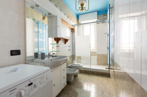 a bathroom with a sink and a toilet and a shower at Roomy Apartment with Balcony! in Milan